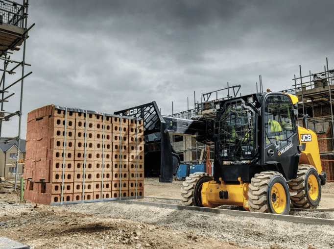 Skid Steer moving pallet of bricks
