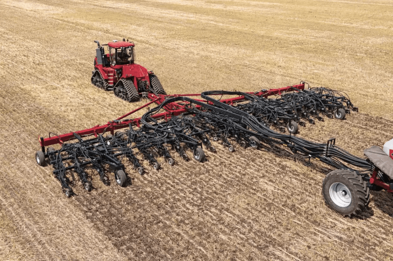 Tractor pulling a rake implement