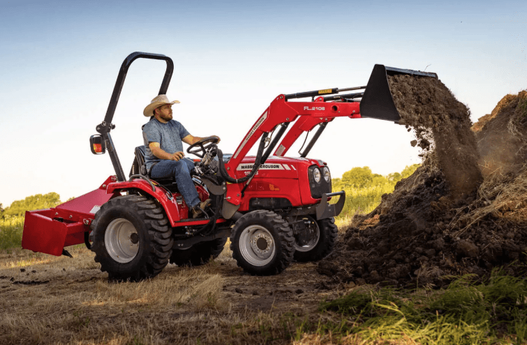 Man operating a compact tractor