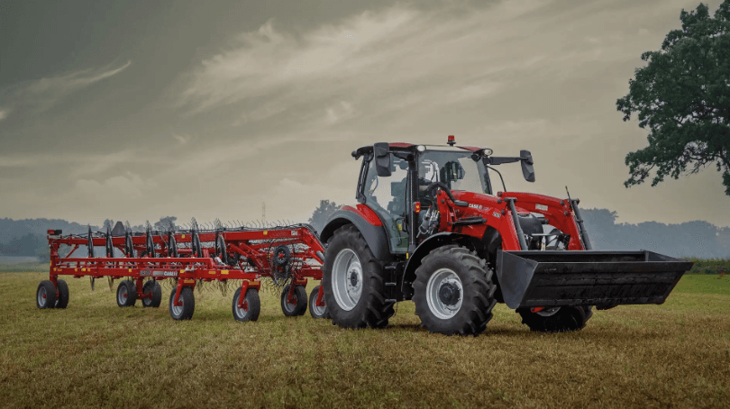 Tractor pulling a hay tool equipment