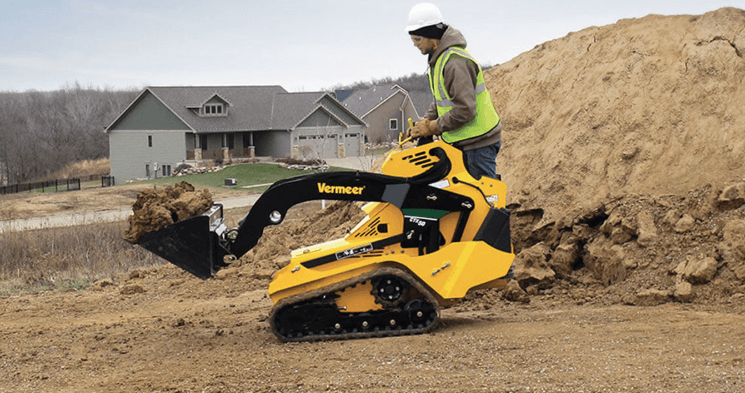 Man operating a stand-on loader