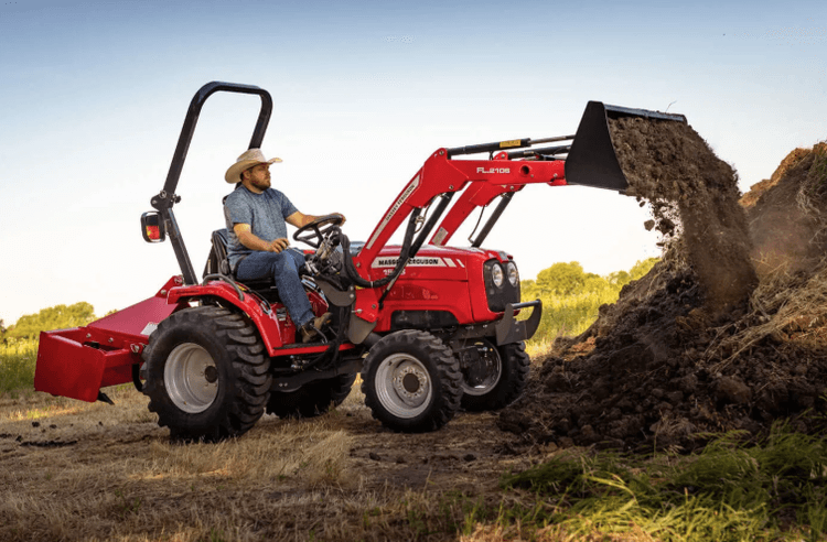 Man operating a compact tractor